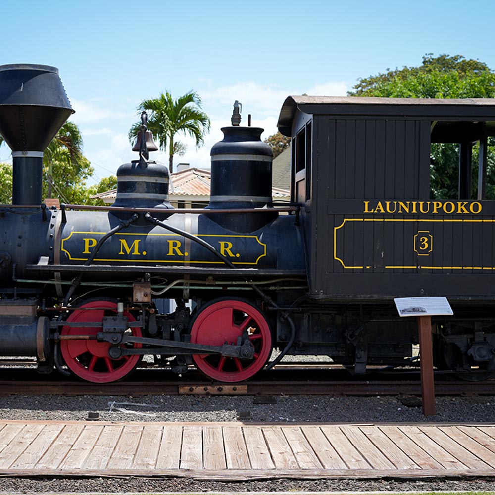 image of historic smokestack and trains in Lahaina.